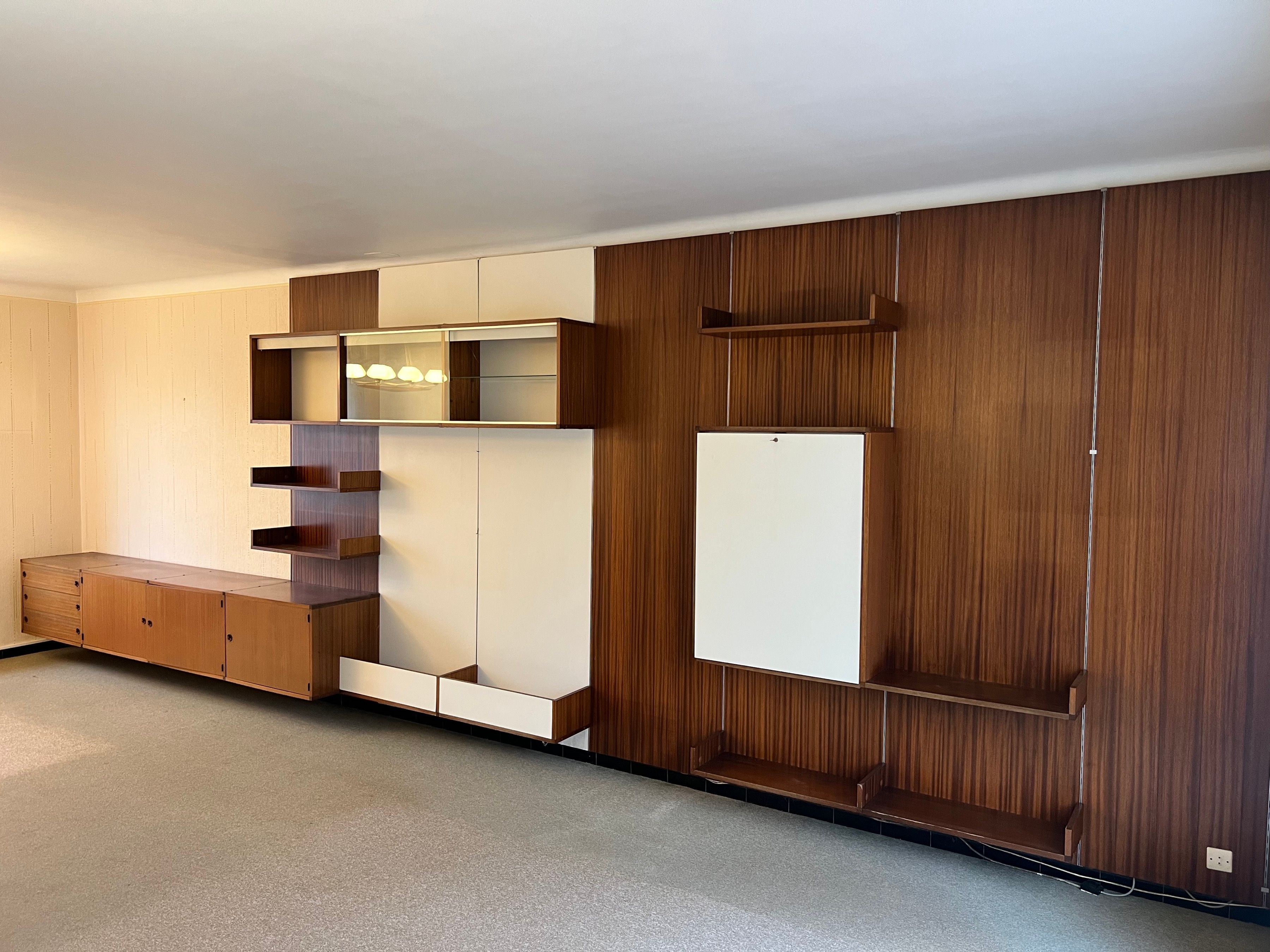 Modular wall system in wood veneer, white laminated wood, glass and brushed metal. French design. Circa 1970