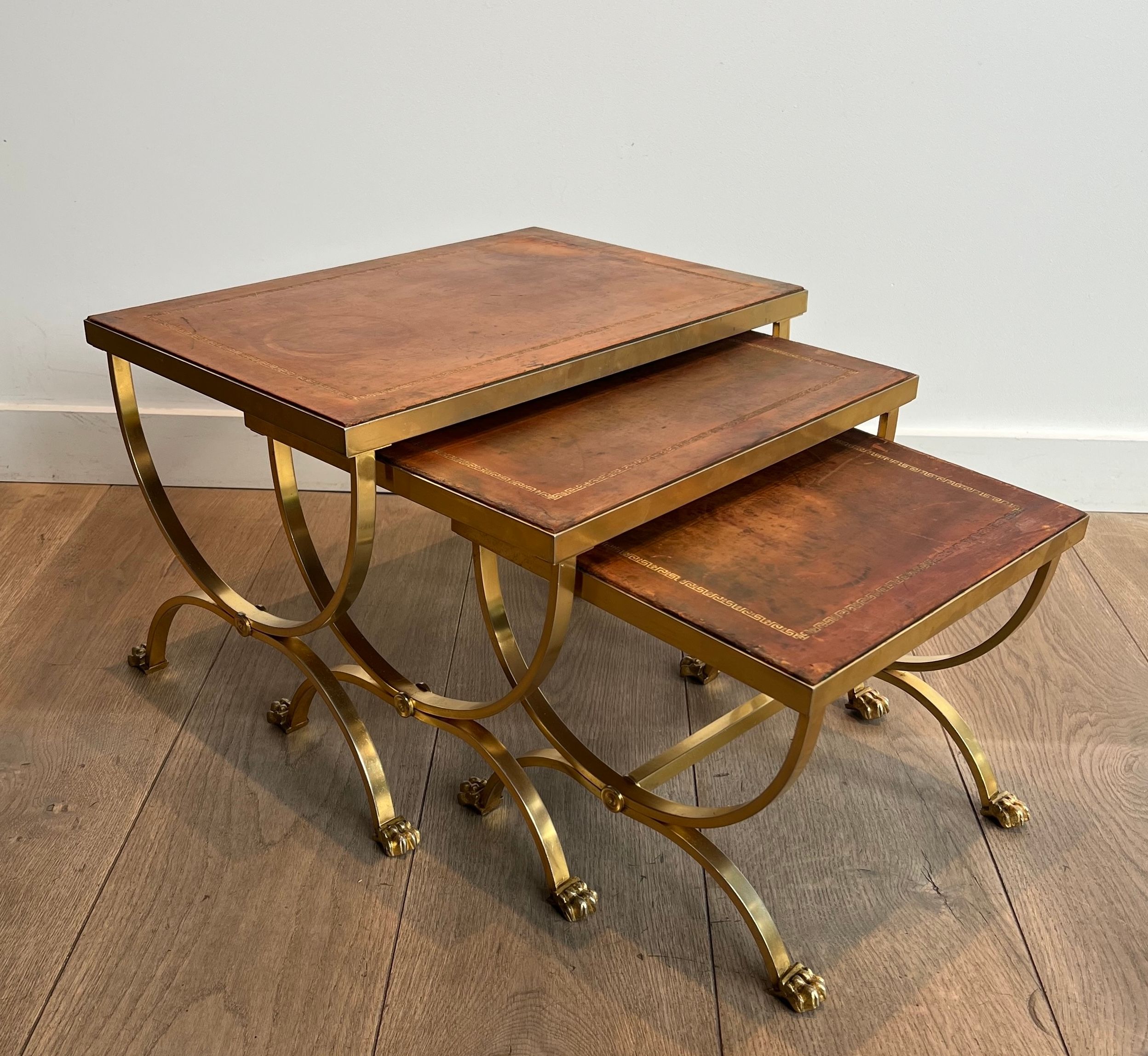 Set of Gilt Metal Nesting Tables with Claw Feet and Leather Tops Attributed by Maison Jansen