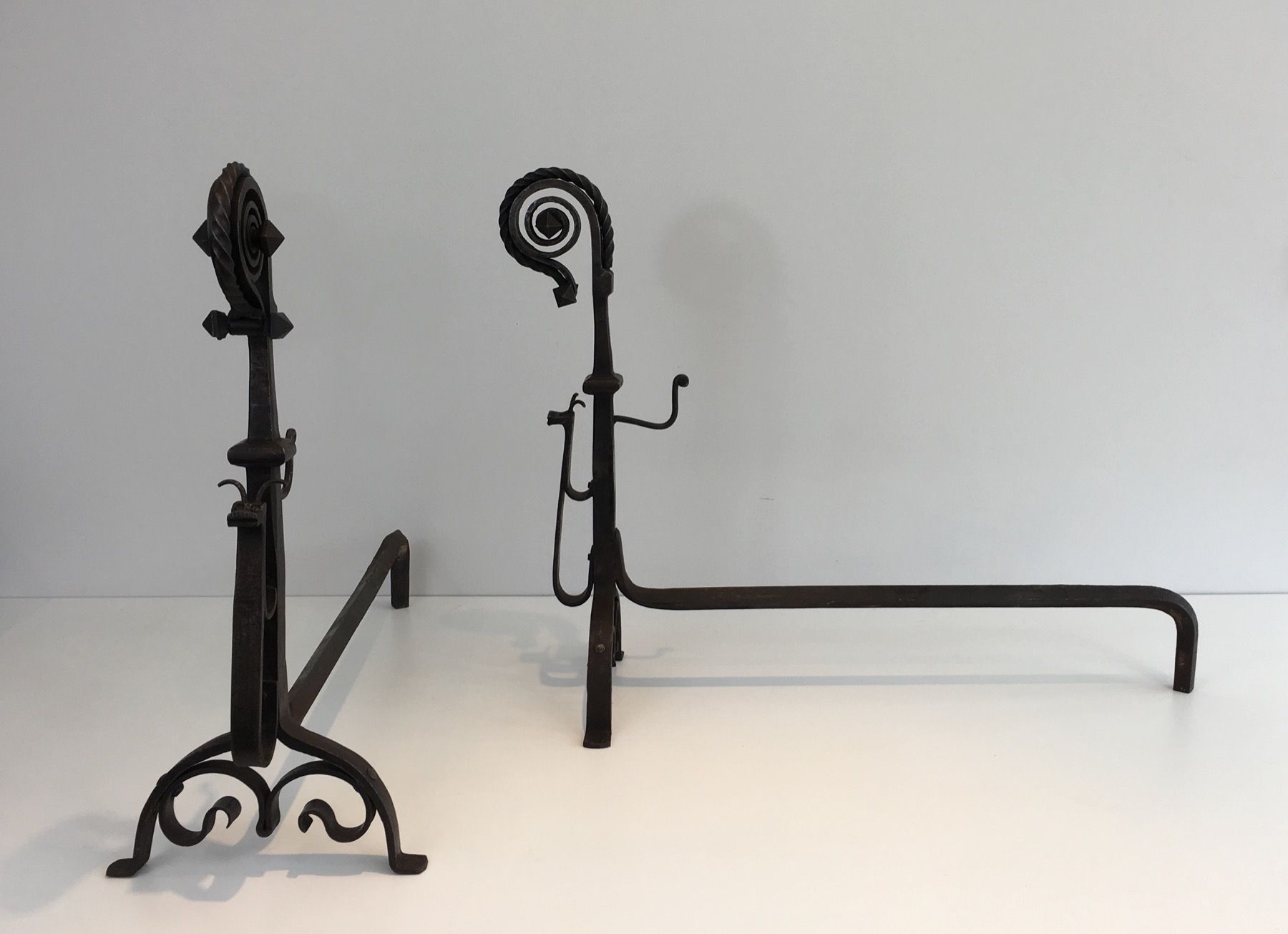 Pair of Tall Wrought Iron Andirons showing a Snail