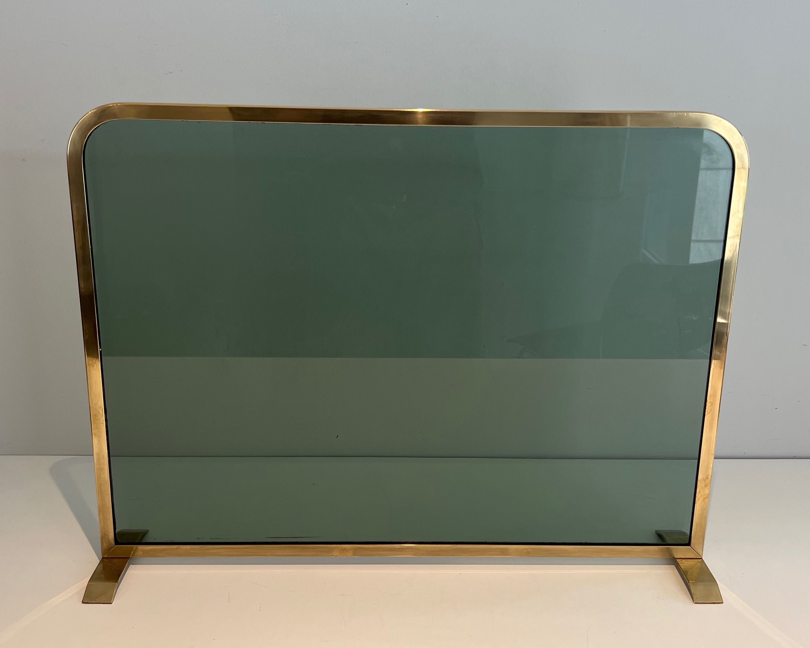 Fireplace Screen Made of a Greenish Glass Panel Surrounded by a Brass Frame