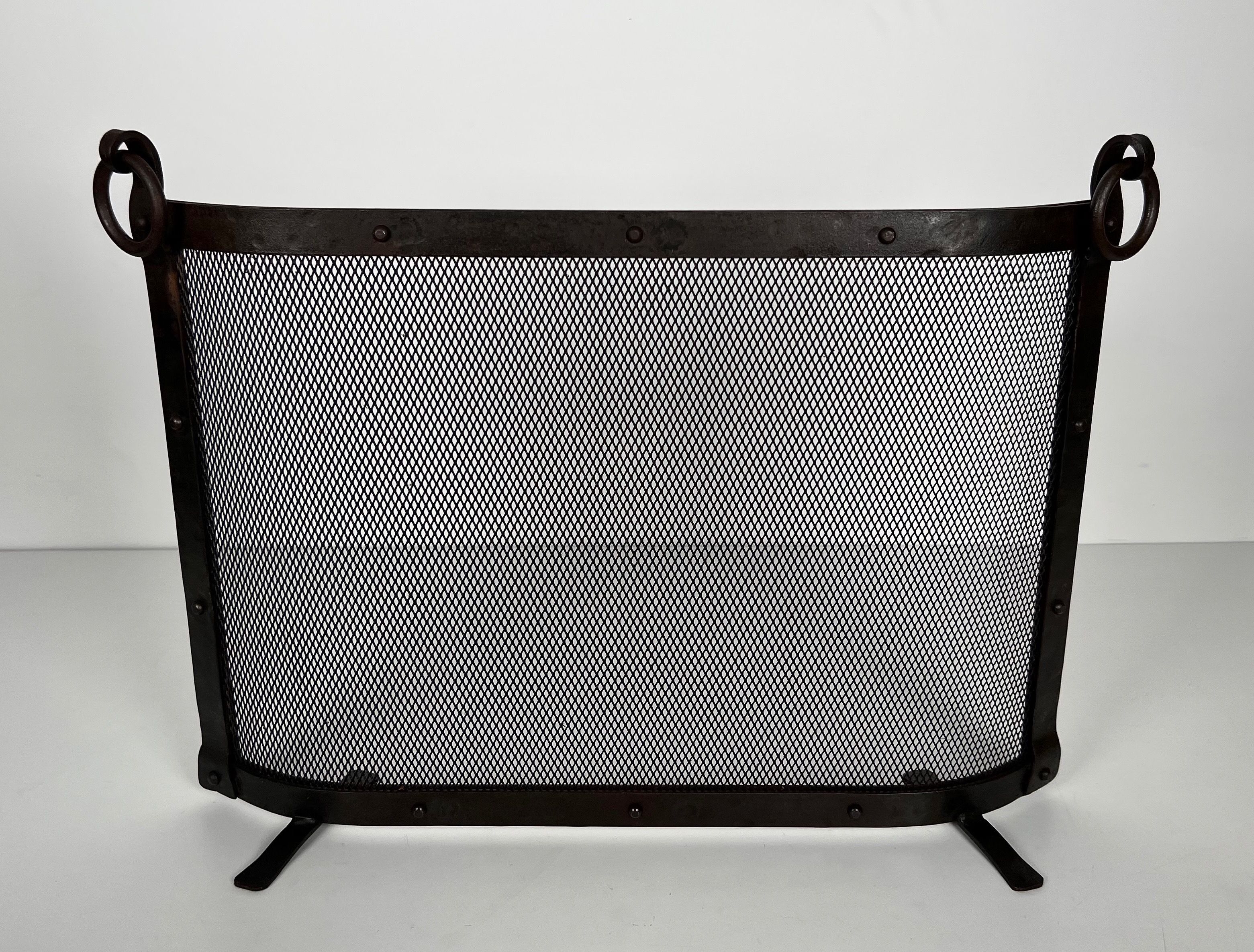 Curved Riveted Wrought Iron Fireplace Screen with Rings in the Style of Jacques Adnet