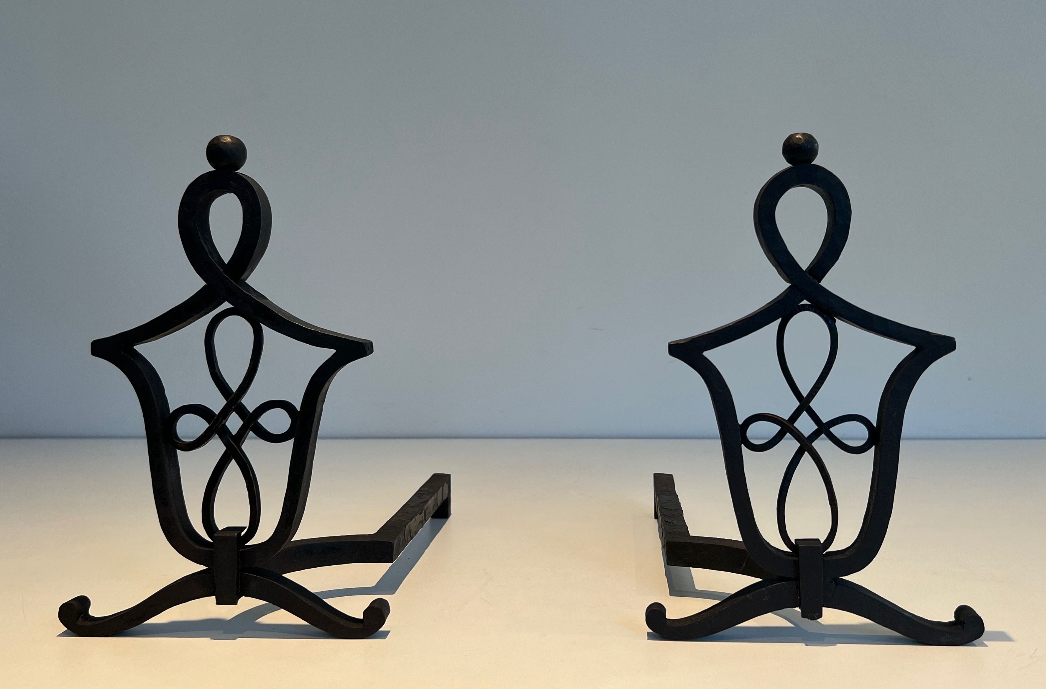 Pair of Wrought Iron Andirons in the style of Raymond Subes