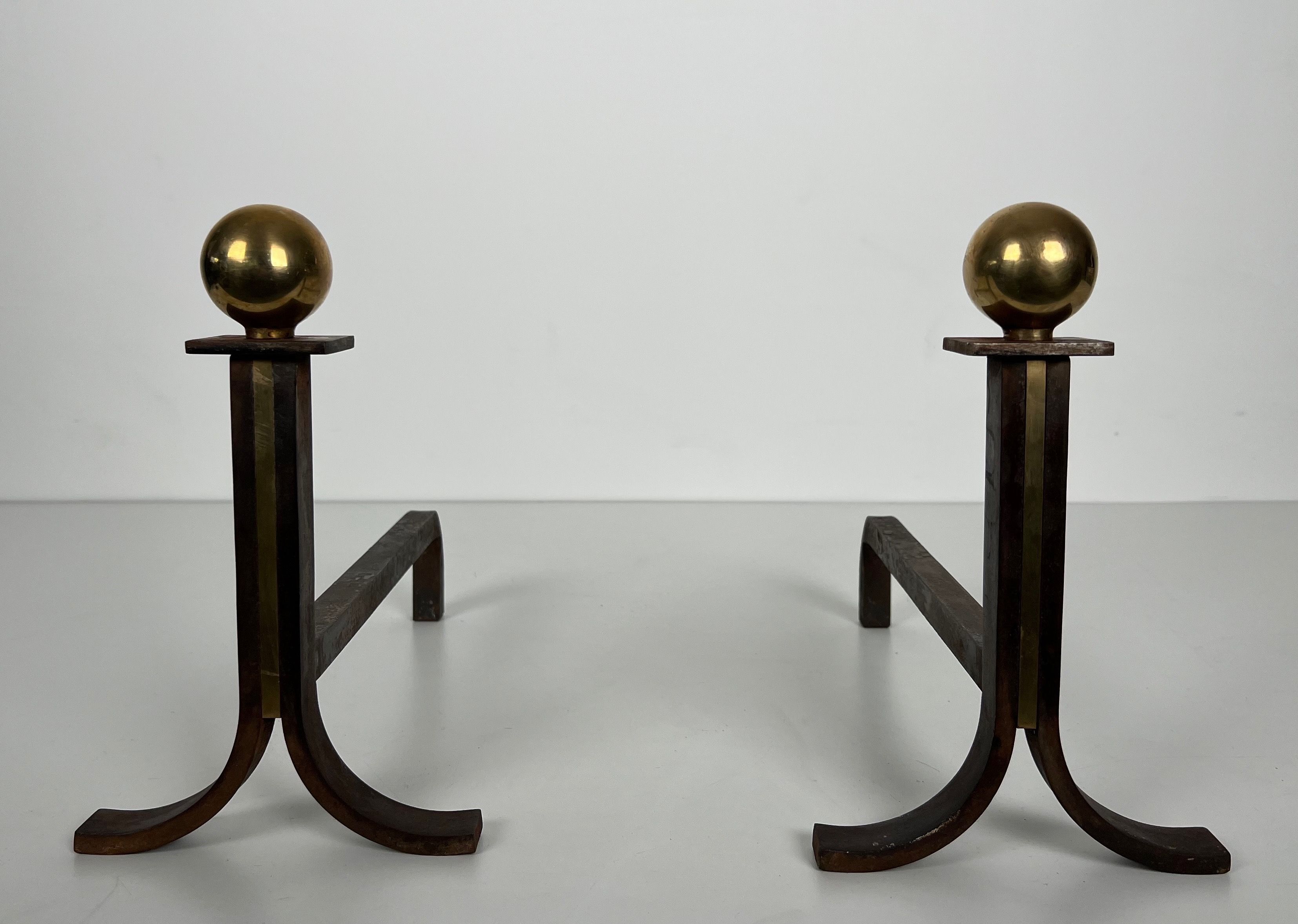 Pair of Modernist Steel, Brass and Wrought Iron Andirons in the Style of Jacques Adnet