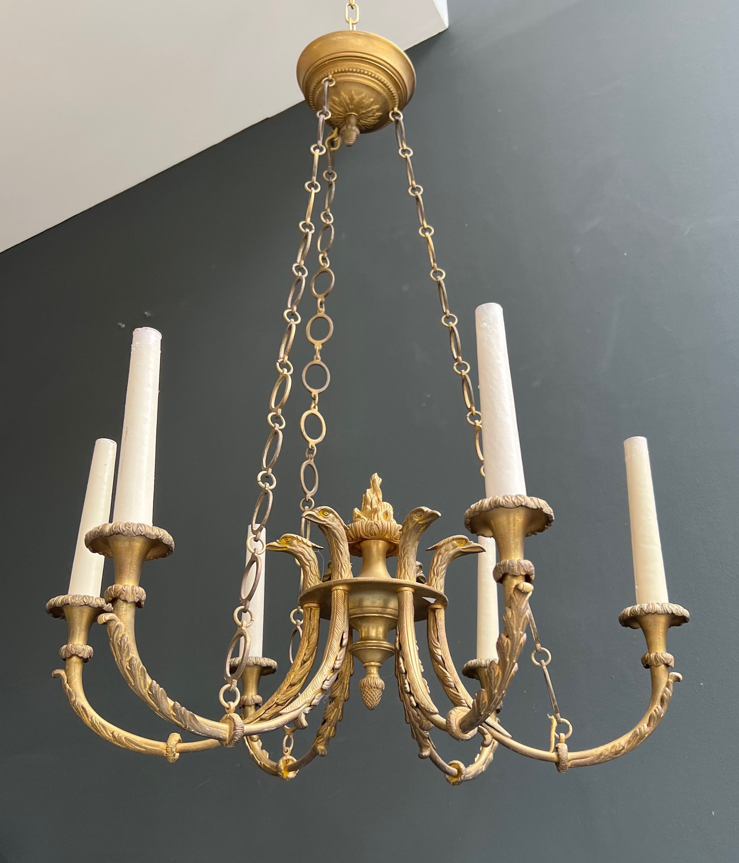 Empire style bronze chandelier with Royal Eagle heads and flame. This chandelier has 6 arms of light. French work. Around 1900