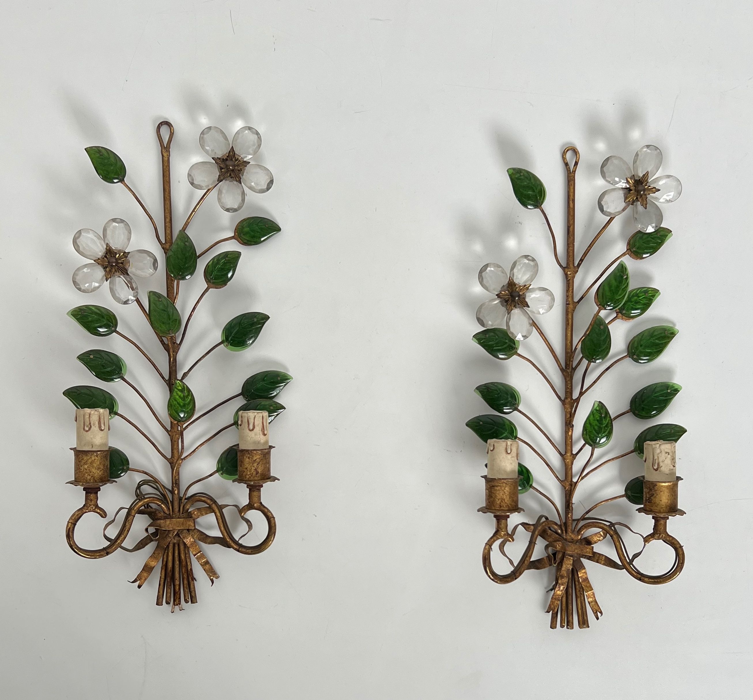 Pair of gilt metal and cut crystals wall sconces decorated with flowers and leaves by Maison Baguès