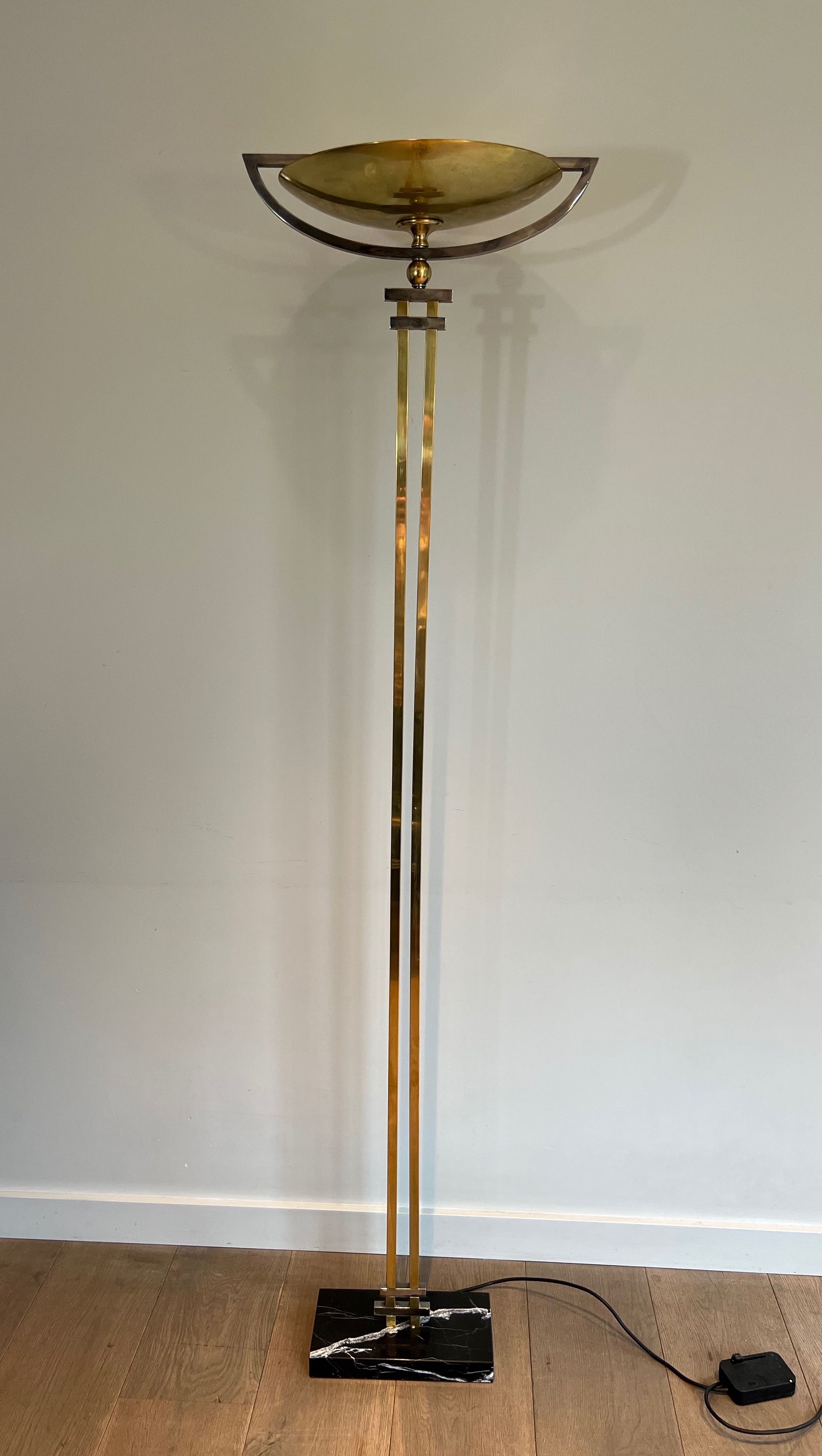 Steel and Brass Floor Lamp, standing on a Black Marble Base. In the Style of Perzel Workshops.