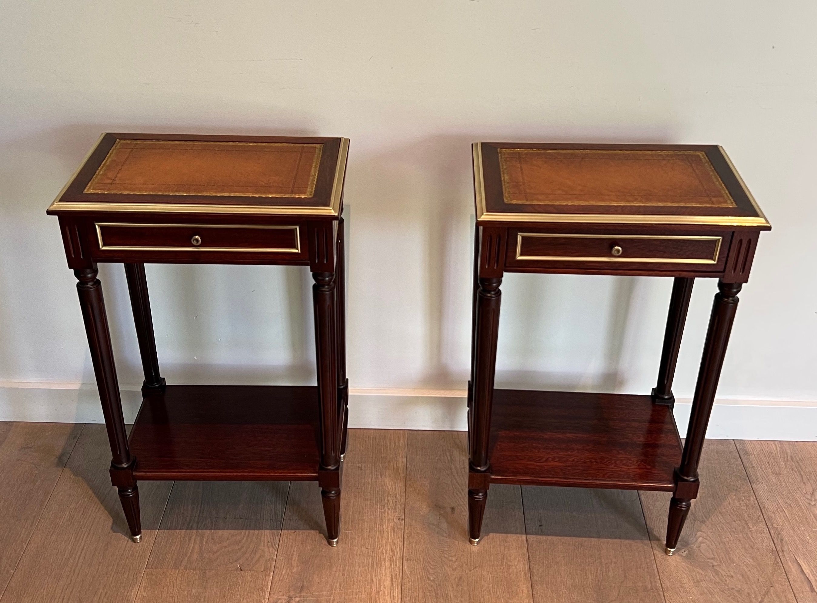 Pair of mahogany and brass side tables with leather tops in the style of Maison Jansen. Circa 1940